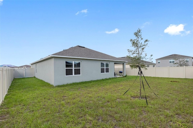 rear view of house with a lawn