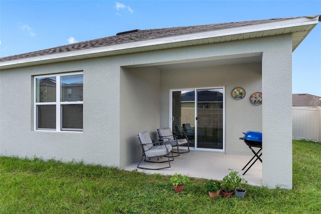 rear view of property featuring a yard