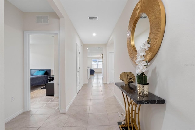 hall featuring light tile patterned floors