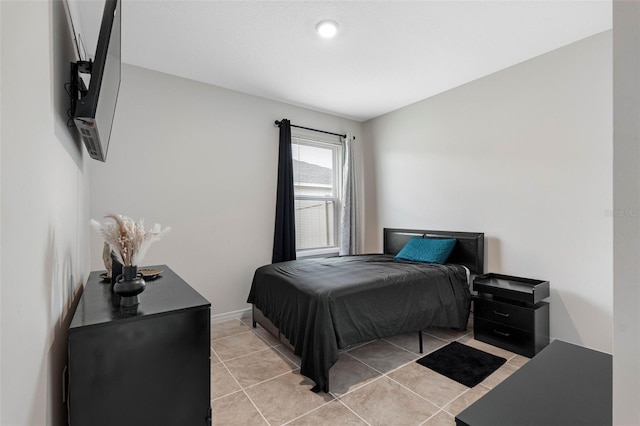 bedroom with light tile patterned floors