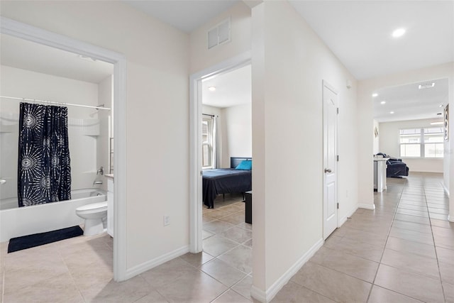 corridor featuring light tile patterned flooring