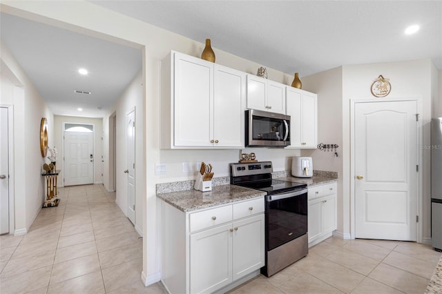 kitchen with white cabinets and appliances with stainless steel finishes