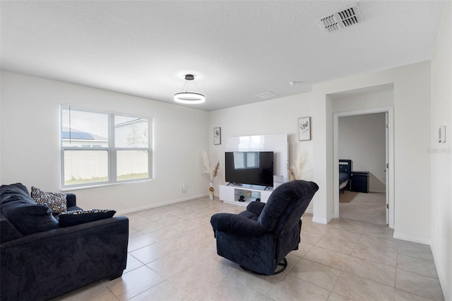 tiled living room with a textured ceiling