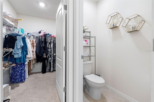 spacious closet featuring light carpet