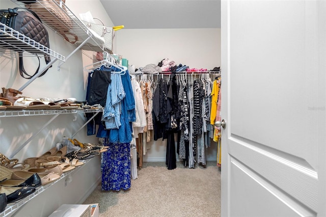 spacious closet featuring light colored carpet