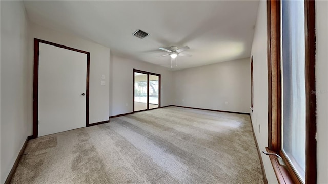 carpeted empty room featuring ceiling fan