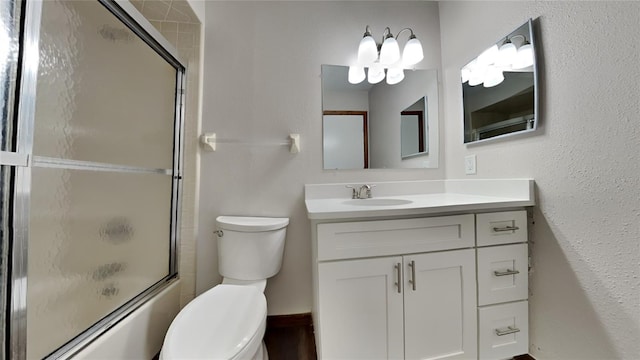 full bathroom with shower / bath combination with glass door, vanity, and toilet