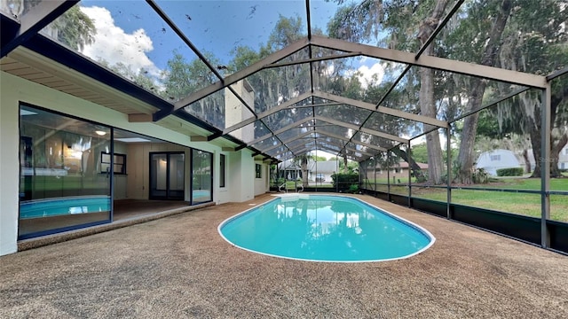 view of pool with a lanai and a patio