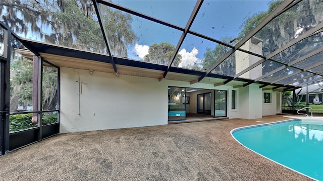 exterior space featuring glass enclosure and a patio area