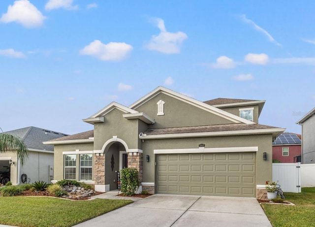 view of property with a front yard and a garage