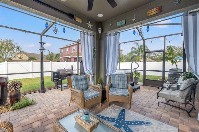 sunroom / solarium featuring ceiling fan and a wealth of natural light