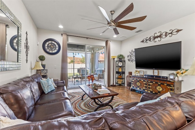 living room featuring ceiling fan and tile patterned floors