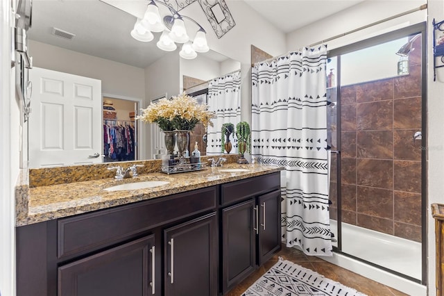 bathroom featuring vanity, walk in shower, and tile patterned flooring