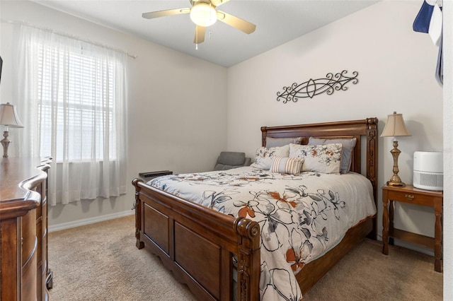 carpeted bedroom featuring ceiling fan and multiple windows