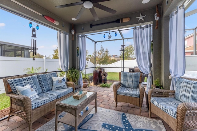 sunroom / solarium featuring ceiling fan and a healthy amount of sunlight