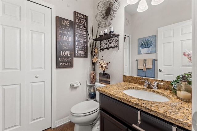 bathroom featuring vanity and toilet