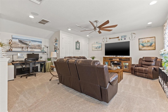 living room with ceiling fan, light carpet, lofted ceiling, and a textured ceiling