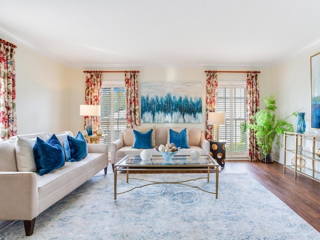 living room with hardwood / wood-style floors and crown molding