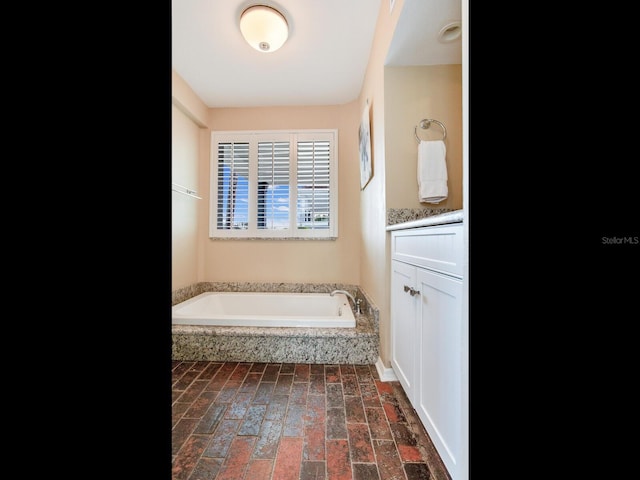 bathroom featuring vanity and a tub to relax in