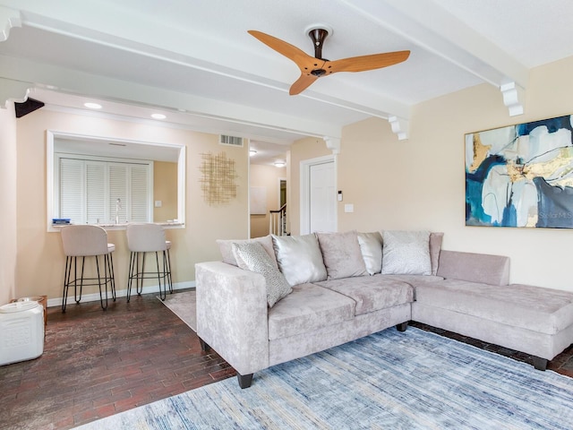 living room featuring ceiling fan and beam ceiling