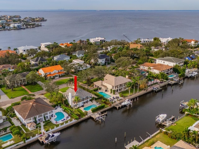 birds eye view of property with a water view