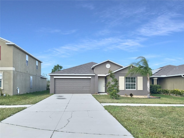 view of front of property featuring a garage and a front yard