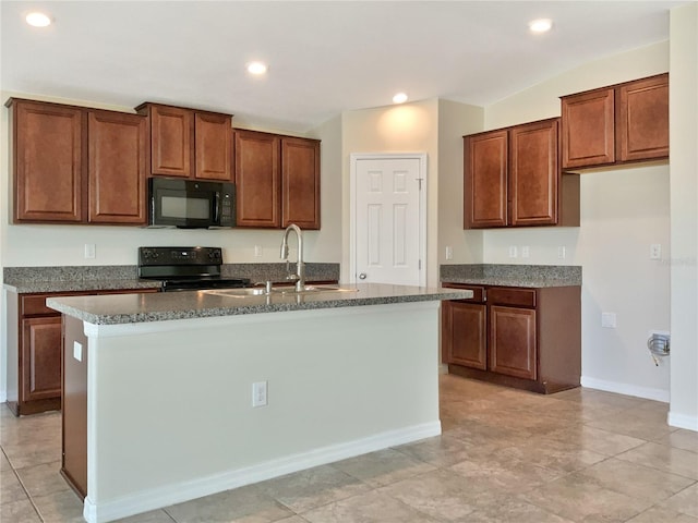 kitchen featuring light tile patterned floors, a kitchen island with sink, sink, and black appliances