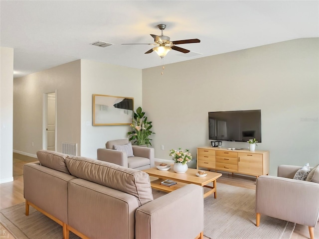 living room featuring ceiling fan and light hardwood / wood-style floors