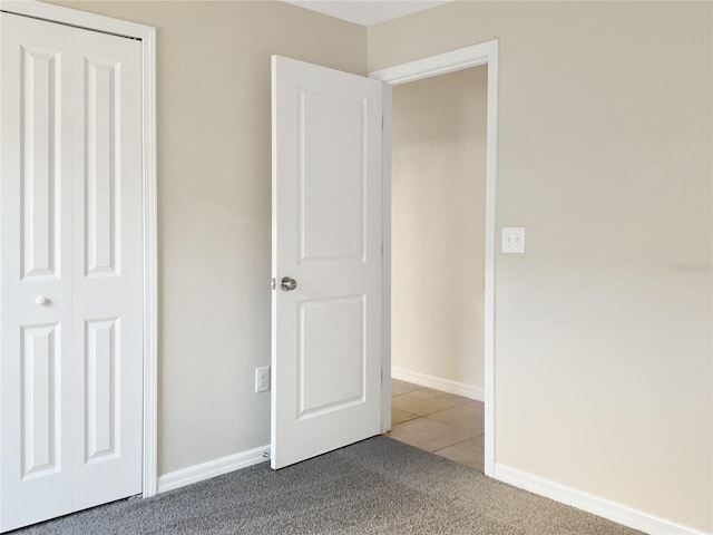 unfurnished bedroom featuring a closet and carpet floors