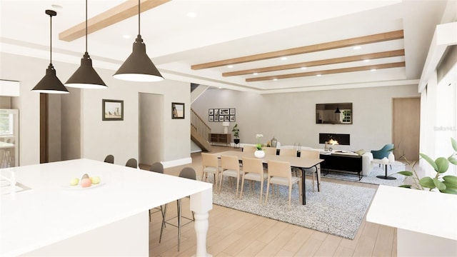 dining space featuring beam ceiling and light hardwood / wood-style flooring