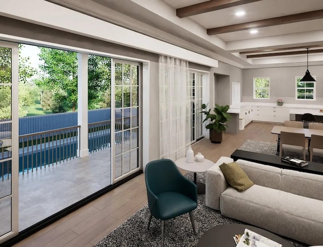 living room featuring beamed ceiling and light hardwood / wood-style floors