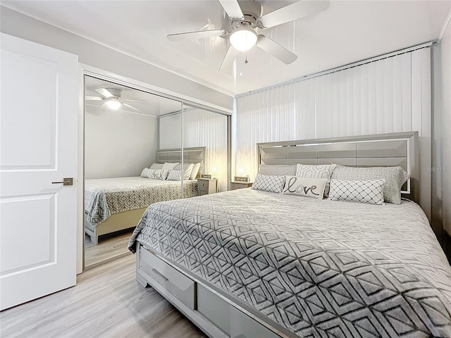 bedroom featuring light wood-type flooring, ceiling fan, and a closet