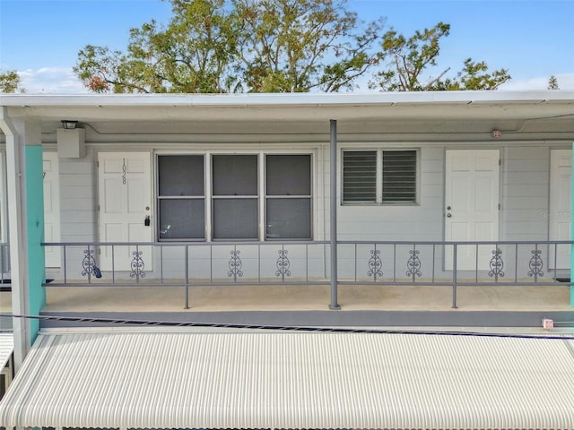 doorway to property with covered porch