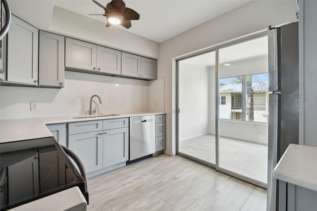 4152 55th Way N Unit 1028, Kenneth City, FL 33709 - kitchen with stainless steel appliances, a sink, gray cabinetry, light countertops, and a ceiling fan