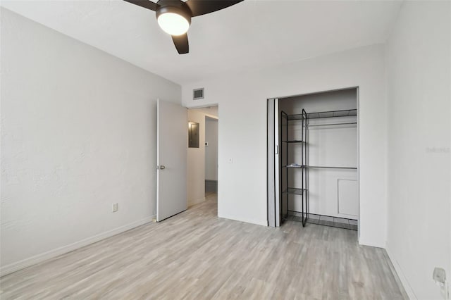 4152 55th Way N Unit 1028, Kenneth City, FL 33709 - unfurnished bedroom featuring light wood-style flooring, a closet, baseboards, and a ceiling fan