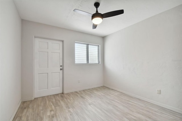 unfurnished room featuring light wood-type flooring and ceiling fan