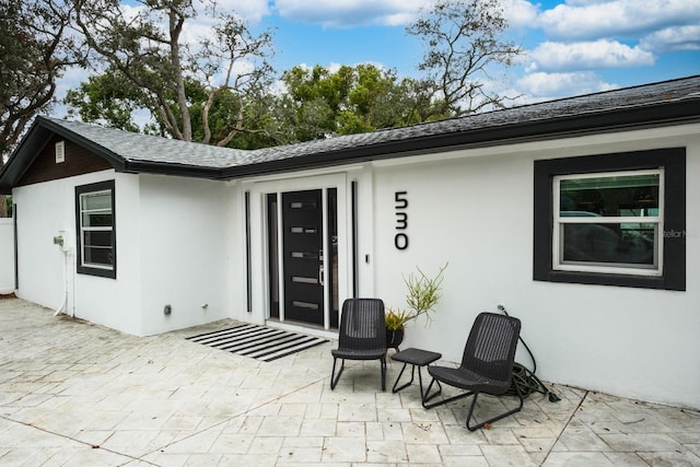 property entrance with a patio