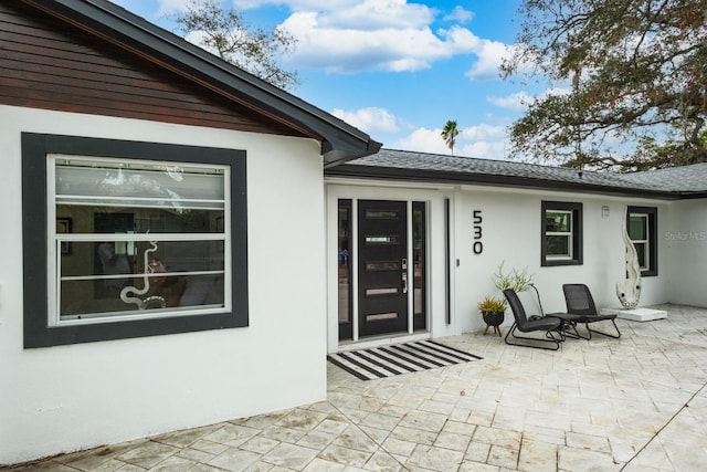 entrance to property with a patio area