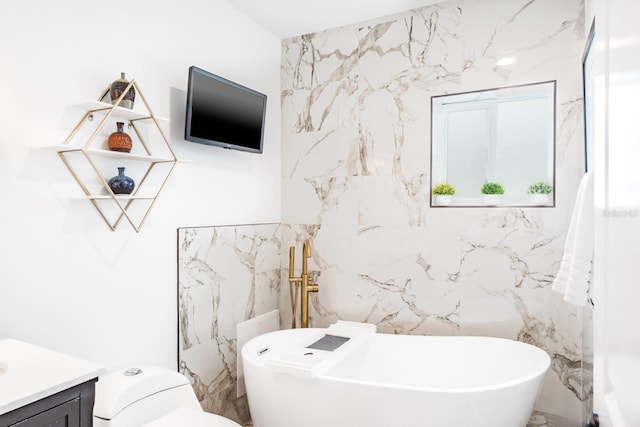 bathroom with vanity, a bathing tub, tile walls, and toilet