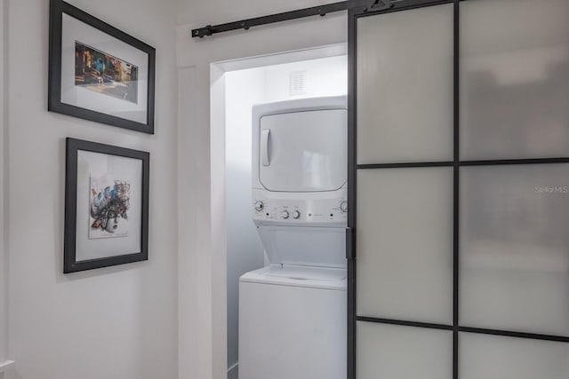 washroom with stacked washer and clothes dryer