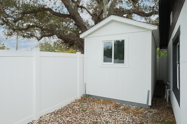 view of side of home with a shed