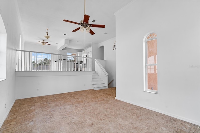 spare room with ceiling fan and crown molding