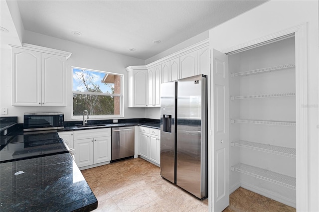 kitchen with white cabinets, stainless steel appliances, and sink