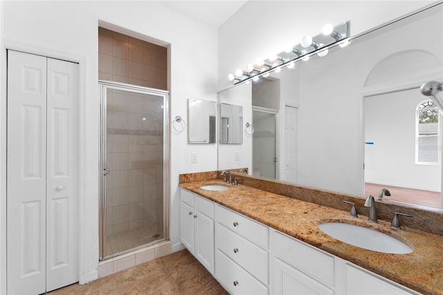 bathroom featuring tile patterned flooring, vanity, and an enclosed shower