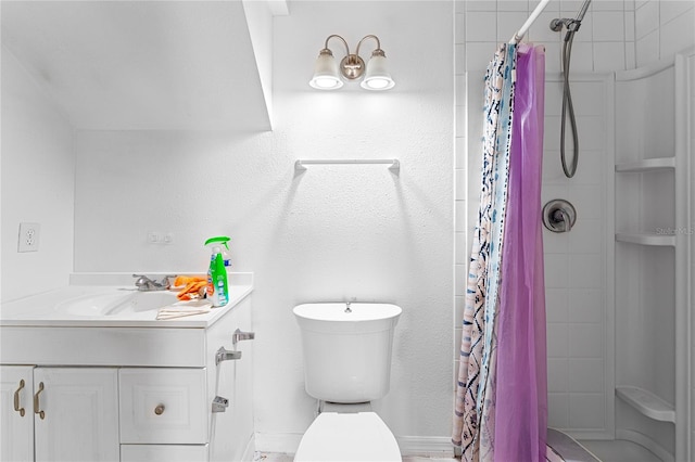 bathroom with vanity, curtained shower, and toilet