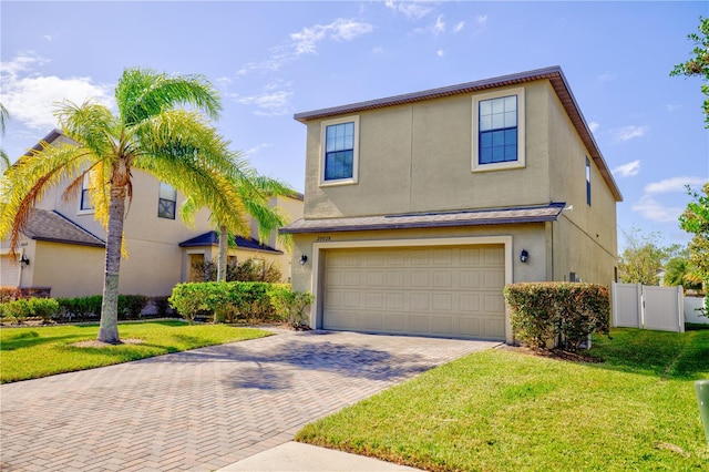 front of property featuring a garage and a front lawn