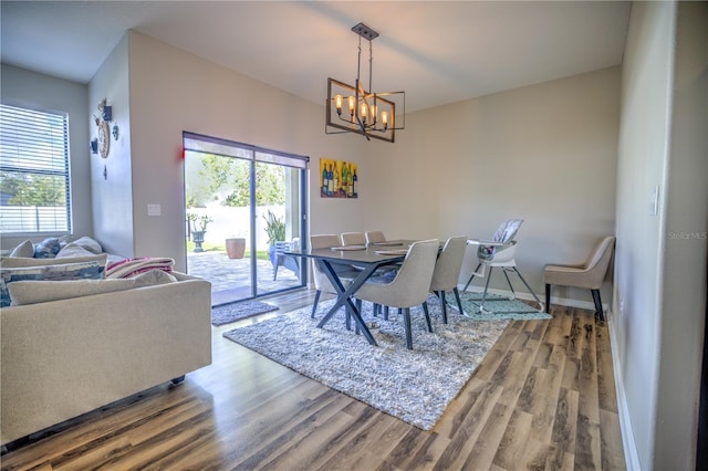 dining room featuring hardwood / wood-style flooring and an inviting chandelier