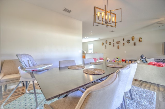 dining room featuring a chandelier and light hardwood / wood-style flooring