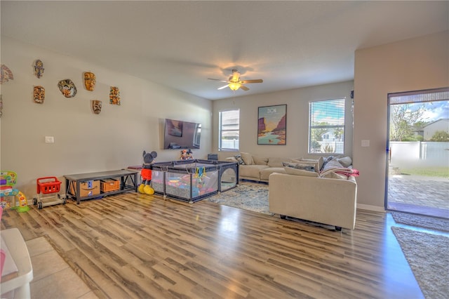 living room featuring wood-type flooring and ceiling fan