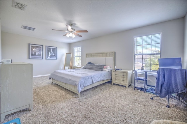 bedroom featuring carpet, multiple windows, and ceiling fan